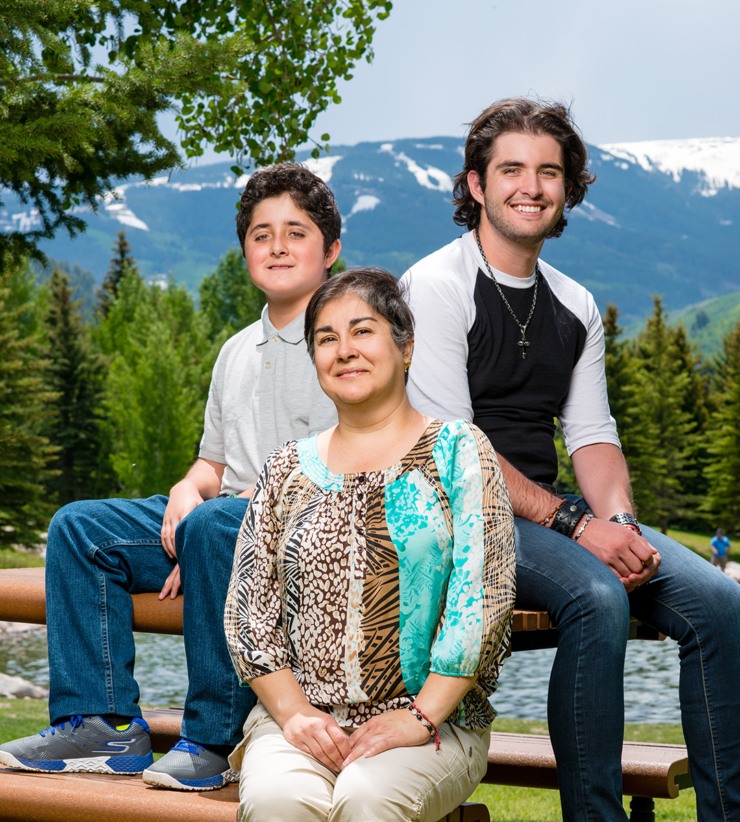 Maria Landeros Lopez with two sons sitting outside